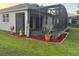 Well-maintained backyard featuring a screened lanai and landscaping at 10414 Andover Point Cir, Orlando, FL 32825
