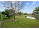 Inviting backyard with green grass and a serene pond view at 10414 Andover Point Cir, Orlando, FL 32825