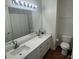 Bathroom featuring double sinks, white cabinets, and a large mirror at 10414 Andover Point Cir, Orlando, FL 32825