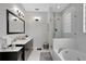 Modern bathroom featuring a glass shower, soaking tub, and a double vanity at 10414 Andover Point Cir, Orlando, FL 32825