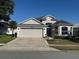 Beautiful home with a two-car garage, well-kept lawn, and inviting curb appeal at 10414 Andover Point Cir, Orlando, FL 32825