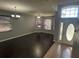 Spacious living room with dark hardwood floors, plentiful windows, and a grand entrance at 10414 Andover Point Cir, Orlando, FL 32825