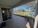 Relaxing screened-in patio with tiled floor overlooking the lake at 10414 Andover Point Cir, Orlando, FL 32825
