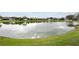 Scenic backyard pond view with lush green lawn at 10414 Andover Point Cir, Orlando, FL 32825