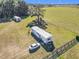 Aerial view showcases a single-Gathering home with a shed and green pasture at 1072 Se 155Th St, Summerfield, FL 34491