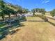Beautiful aerial view of a property featuring a lush lawn, a carport, shed, and well-maintained landscaping at 1072 Se 155Th St, Summerfield, FL 34491