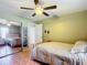 Bright bedroom with a large closet, ceiling fan, light green walls and wood-look tile flooring at 1072 Se 155Th St, Summerfield, FL 34491