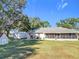 Spacious backyard featuring a shed, brick outdoor kitchen, and screened-in porch, perfect for outdoor enjoyment at 1072 Se 155Th St, Summerfield, FL 34491