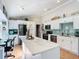 Bright kitchen featuring white cabinets, stainless steel appliances, a spacious island, and stylish countertops at 1072 Se 155Th St, Summerfield, FL 34491