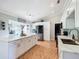 Bright kitchen featuring white cabinets, stainless steel appliances, a spacious island, and stylish countertops at 1072 Se 155Th St, Summerfield, FL 34491