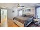 Comfortable main bedroom features a ceiling fan, neutral walls and wood-look tile flooring at 1072 Se 155Th St, Summerfield, FL 34491