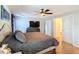 Spacious main bedroom with a ceiling fan, neutral-toned walls, and an ensuite bathroom at 1072 Se 155Th St, Summerfield, FL 34491