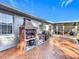 Outdoor kitchen with a brick oven, grill, and ample counter space for entertaining guests at 1072 Se 155Th St, Summerfield, FL 34491