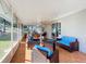 Enclosed patio featuring tile flooring, outdoor seating, and views of the backyard and lawn at 1072 Se 155Th St, Summerfield, FL 34491