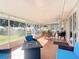 Enclosed patio with tiled flooring, outdoor seating, and access to the backyard at 1072 Se 155Th St, Summerfield, FL 34491