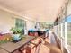Spacious enclosed patio featuring tiled flooring, outdoor seating, and views of the backyard at 1072 Se 155Th St, Summerfield, FL 34491