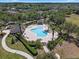 Aerial view of a community pool surrounded by lush landscaping and palm trees at 11407 Wakeworth St, Orlando, FL 32836