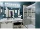 Stylish bathroom featuring a glass enclosed shower, vanity with make up seat, and modern fixtures at 11407 Wakeworth St, Orlando, FL 32836