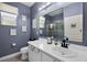 Well lit bathroom featuring a shower, and a vanity with white cabinets and drawers at 11407 Wakeworth St, Orlando, FL 32836