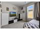 Cozy bedroom featuring a modern TV, keyboard, and comfortable bed with decorative wall art at 11407 Wakeworth St, Orlando, FL 32836