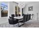 Dining room with a modern table, seating for eight, and large windows for natural light at 11407 Wakeworth St, Orlando, FL 32836