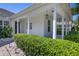 Inviting front porch featuring white pillars and manicured landscaping enhancing the home's curb appeal at 11407 Wakeworth St, Orlando, FL 32836