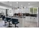 Bright kitchen featuring an island with bar stools, white cabinets, and stainless steel appliances at 11407 Wakeworth St, Orlando, FL 32836