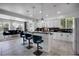 Bright kitchen features a breakfast bar with seating, modern appliances, and views into the dining area at 11407 Wakeworth St, Orlando, FL 32836