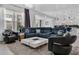 Open concept living room and kitchen with a plush sectional sofa and sleek furnishings at 11407 Wakeworth St, Orlando, FL 32836