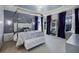Serene main bedroom with a four-poster bed, elegant decor, and plenty of natural light at 11407 Wakeworth St, Orlando, FL 32836