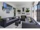 Cozy screened-in patio with a comfortable seating area, mounted TV, and decorative fireplace at 11407 Wakeworth St, Orlando, FL 32836