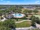 Community pool area showcasing lush landscaping and a convenient cabana, perfect for relaxing and socializing at 11407 Wakeworth St, Orlando, FL 32836
