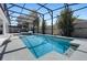 Relaxing screened-in pool area with sparkling blue water and ample space for lounging at 11407 Wakeworth St, Orlando, FL 32836