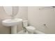 Simple bathroom featuring a pedestal sink, toilet, neutral color walls and essential fixtures at 11941 Bracco St, Winter Garden, FL 34787