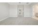 A neutral bedroom with plush carpet flooring, double door entryways, and an attached bathroom at 11941 Bracco St, Winter Garden, FL 34787
