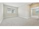 Spacious bedroom with neutral carpet, two windows, and a doorway to another room at 11941 Bracco St, Winter Garden, FL 34787