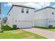 Charming two-story home with a brick driveway, attached garage and manicured lawn at 11941 Bracco St, Winter Garden, FL 34787