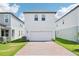 Modern two-story home featuring a brick driveway, white siding, and well-manicured lawn at 11941 Bracco St, Winter Garden, FL 34787