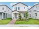 Charming two-story home features a well-manicured lawn, inviting front porch and lovely landscaping at 11941 Bracco St, Winter Garden, FL 34787
