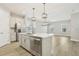 Contemporary kitchen featuring a central island, stainless steel appliances, and sleek white cabinetry at 11941 Bracco St, Winter Garden, FL 34787