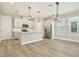 Modern kitchen featuring stainless steel appliances, white cabinets, a central island, and stylish pendant lighting at 11941 Bracco St, Winter Garden, FL 34787