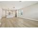 Bright, open-concept living room features hardwood floors, modern lighting, and a view into the kitchen at 11941 Bracco St, Winter Garden, FL 34787