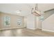 An open concept living room boasts hardwood floors, natural light, and modern light fixtures at 11941 Bracco St, Winter Garden, FL 34787