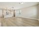 Bright living room featuring hardwood floors, modern lighting, and an open floor plan to the kitchen at 11941 Bracco St, Winter Garden, FL 34787