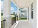 Covered porch features elegant columns, black metal railing, and a view of the neighborhood at 11941 Bracco St, Winter Garden, FL 34787