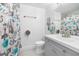 Bathroom featuring a modern vanity, stylish shower curtain, and neutral tile flooring at 12133 Augusta Woods Cir, Orlando, FL 32824