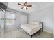 Bright bedroom with wood-look floors, closet, and a sunny window at 12133 Augusta Woods Cir, Orlando, FL 32824