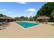 Community pool area with lounge chairs and shade, perfect for relaxing at 12133 Augusta Woods Cir, Orlando, FL 32824