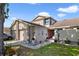 Home featuring a 2-car garage, neutral paint, and well-manicured landscaping at 12133 Augusta Woods Cir, Orlando, FL 32824