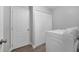 Laundry room with white doors and a large capacity washing machine at 12133 Augusta Woods Cir, Orlando, FL 32824